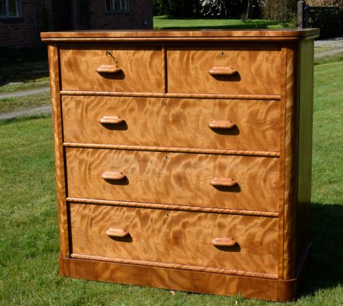 fig 2. Victorian golden birch chest of drawers featuring a two-over-three drawer configuration, rounded corners, integrated timber handles, and a plinth base.