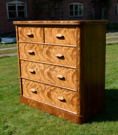 fig 3. Victorian golden birch chest of drawers featuring a two-over-three drawer configuration, rounded corners, integrated timber handles, and a plinth base.