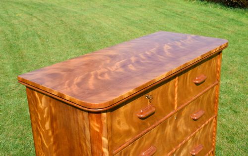 fig 4. Victorian golden birch chest of drawers featuring a two-over-three drawer configuration, rounded corners, integrated timber handles, and a plinth base.