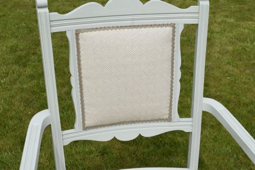 fig 5. A pair of painted pale green Edwardian open armchairs featuring cream upholstered seats, padded backrest panels, turned front legs, and scalloped top rails.