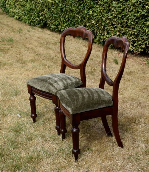 fig 2. A pair of Victorian mahogany crown back dining chairs with green velvet upholstered seats and turned front legs.