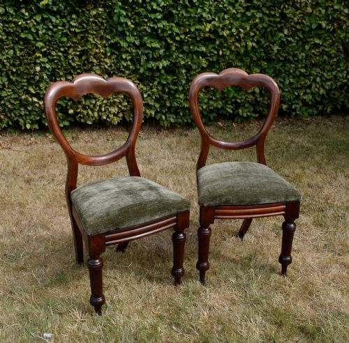 fig 4. A pair of Victorian mahogany crown back dining chairs with green velvet upholstered seats and turned front legs.