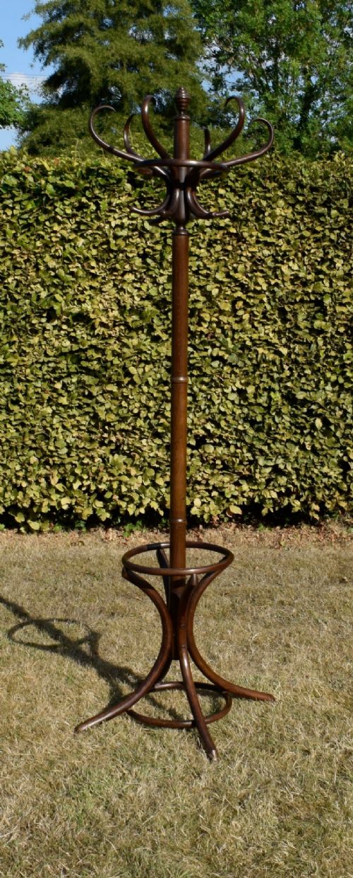 A dark brown bentwood coat and hat stand featuring curved upper hooks, a turned central post, an umbrella ring, and curved tripod legs. View XII