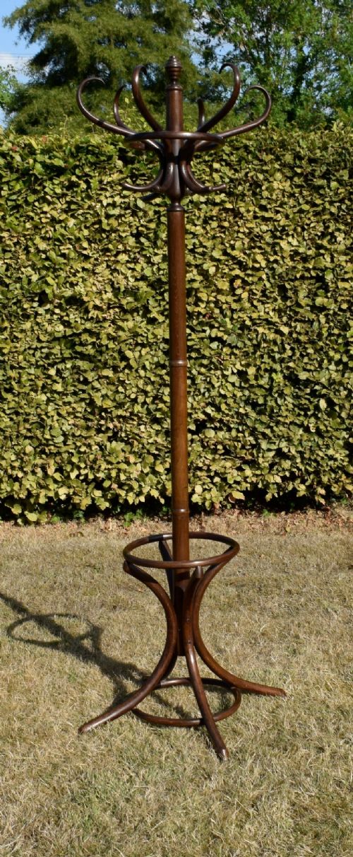 A dark brown bentwood coat and hat stand featuring curved upper hooks, a turned central post, an umbrella ring, and curved tripod legs. View XIII
