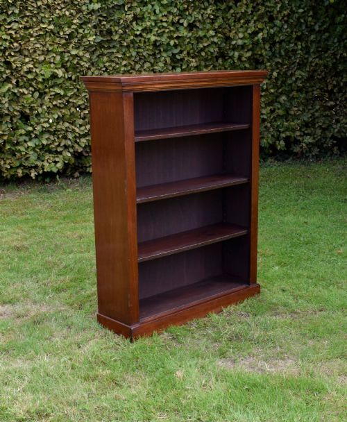 fig 1. An early 20th-century open-front mahogany bookcase featuring three internal shelves, a moulded top cornice, and a sturdy plinth base.