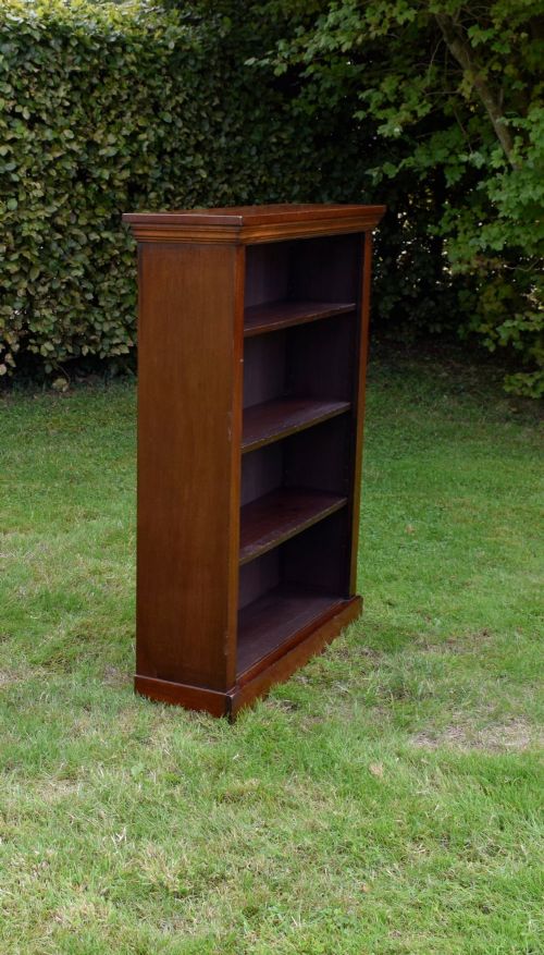 fig 2. An early 20th-century open-front mahogany bookcase featuring three internal shelves, a moulded top cornice, and a sturdy plinth base.