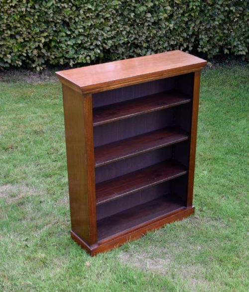 fig 4. An early 20th-century open-front mahogany bookcase featuring three internal shelves, a moulded top cornice, and a sturdy plinth base.