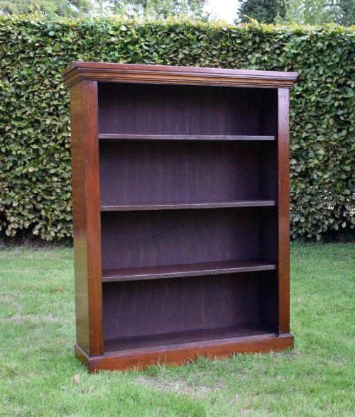 fig 5. An early 20th-century open-front mahogany bookcase featuring three internal shelves, a moulded top cornice, and a sturdy plinth base.
