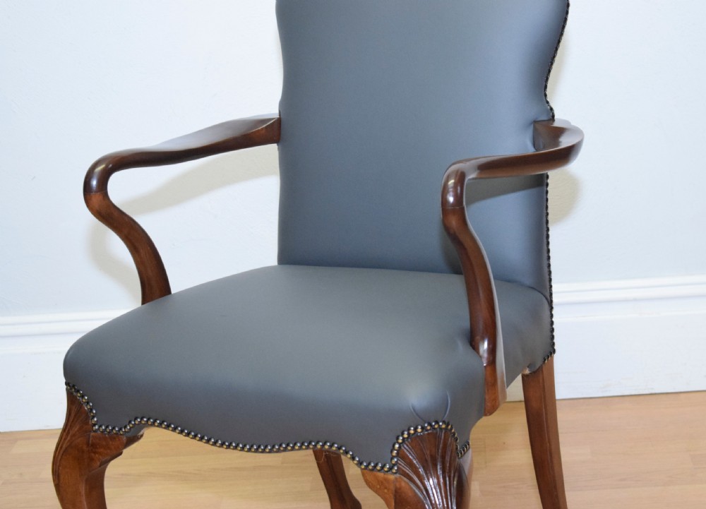 A Queen Anne style grey leather upholstered desk chair featuring carved mahogany cabriole legs, brass studding detail, and sweeping arms. View IX