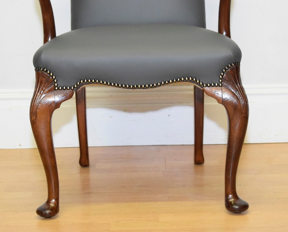 A Queen Anne style grey leather upholstered desk chair featuring carved mahogany cabriole legs, brass studding detail, and sweeping arms. View XV