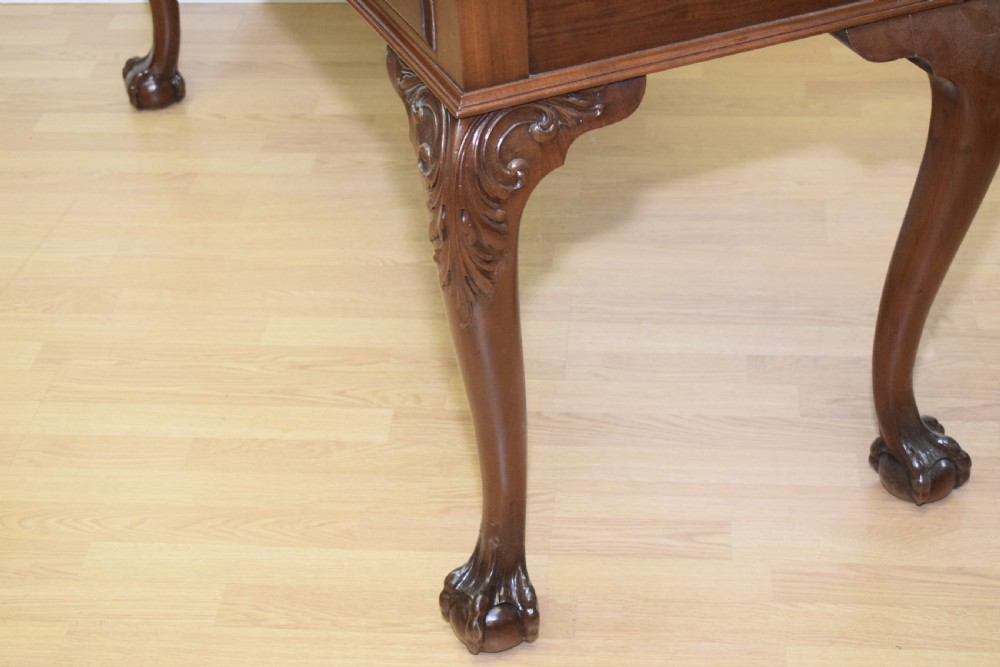 A mahogany library writing table featuring a green leather inset top, brass drop handles, and carved cabriole legs terminating in claw and ball feet. View XIV