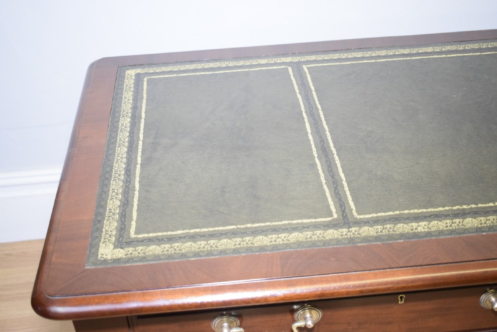 A mahogany library writing table featuring a green leather inset top, brass drop handles, and carved cabriole legs terminating in claw and ball feet. View XIX
