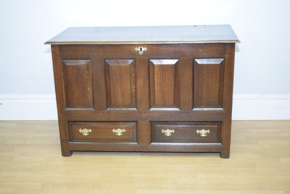 A dark Georgian oak mule chest featuring four fielded front panels and two lower drawers with brass swan-neck handles. View XIV
