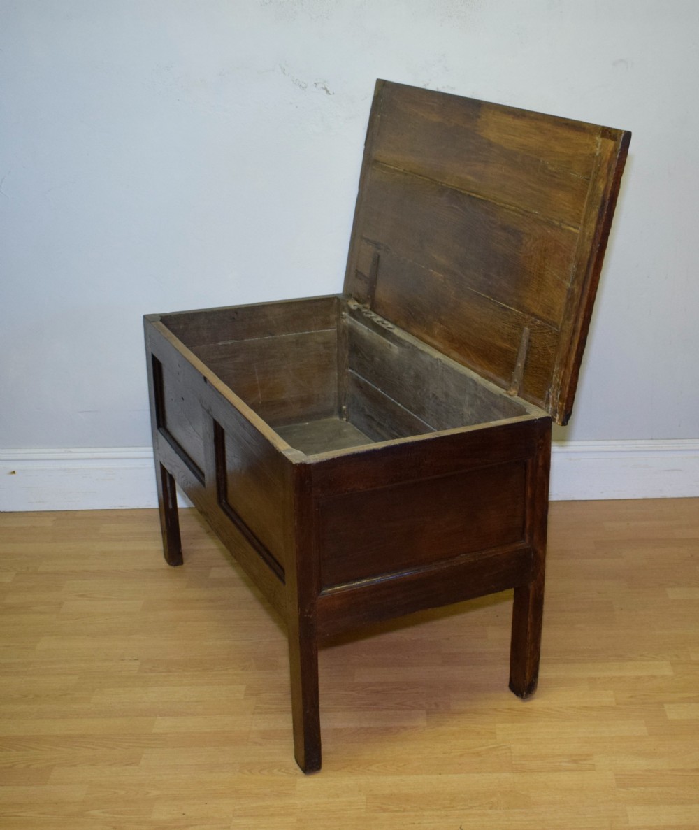A dark oak seventeenth-century coffer featuring two plain rectangular front panels and a flat hinged top. View XVIII