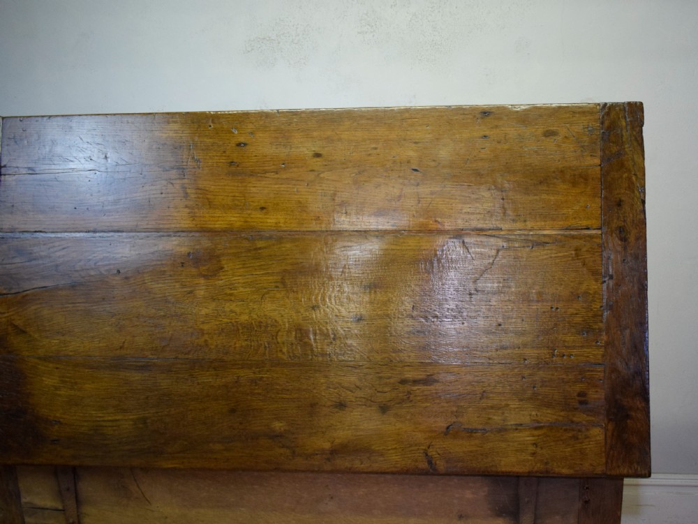 A dark oak seventeenth-century coffer featuring two plain rectangular front panels and a flat hinged top. View XXI