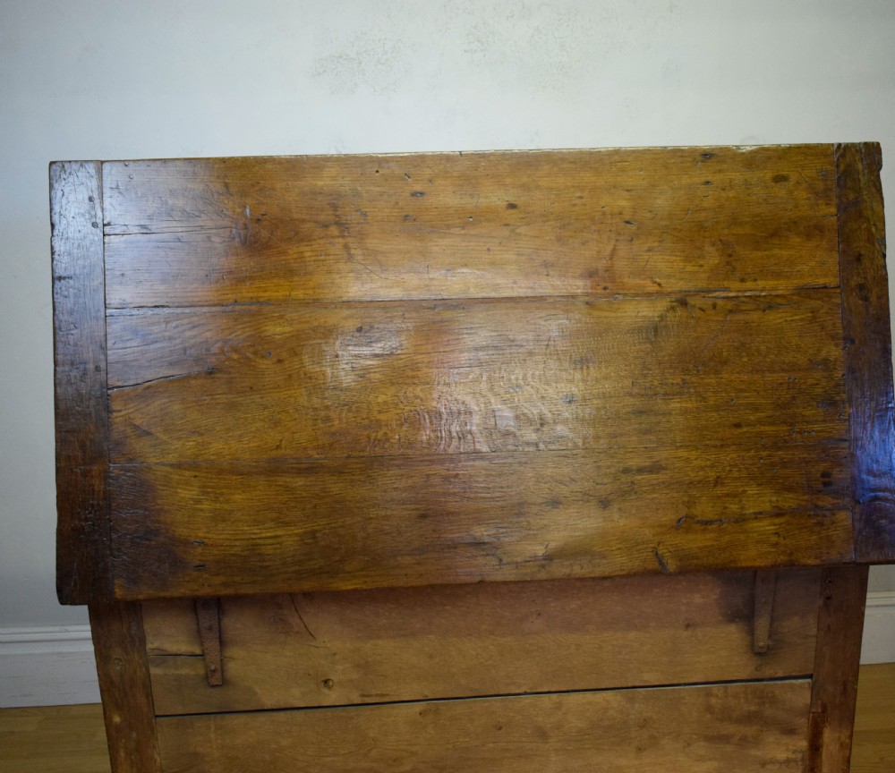 A dark oak seventeenth-century coffer featuring two plain rectangular front panels and a flat hinged top. View XXIII