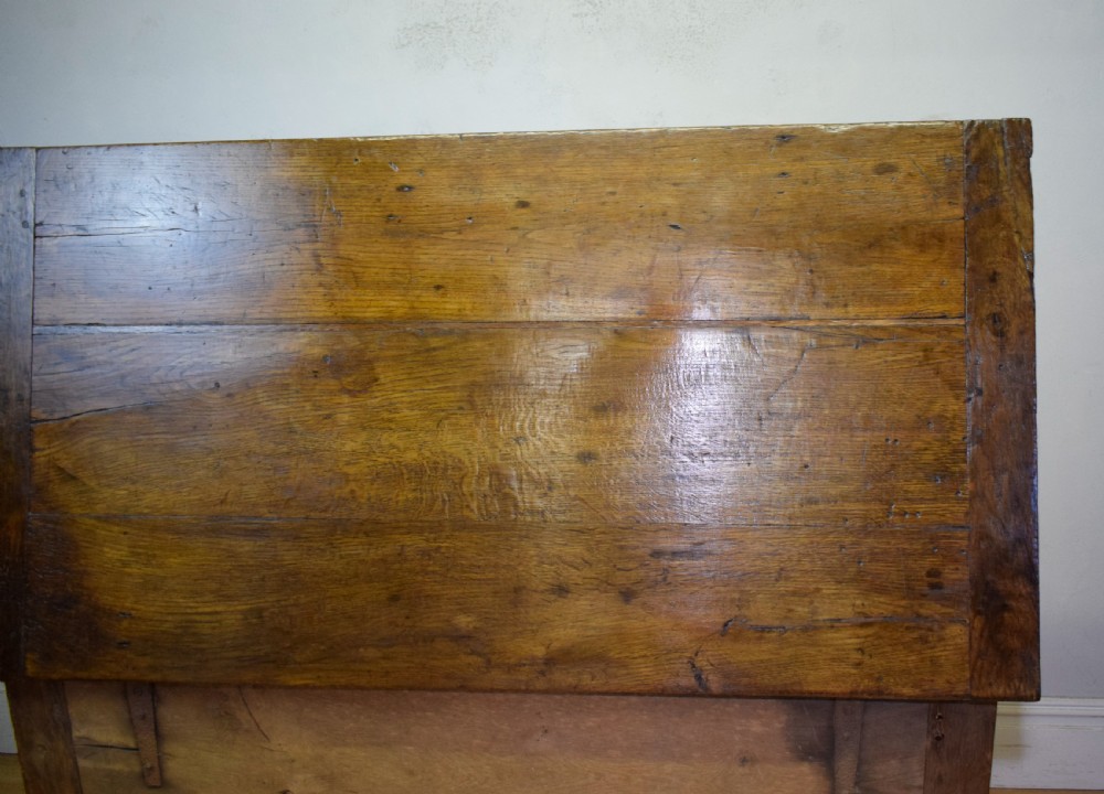 A dark oak seventeenth-century coffer featuring two plain rectangular front panels and a flat hinged top. View XXIV