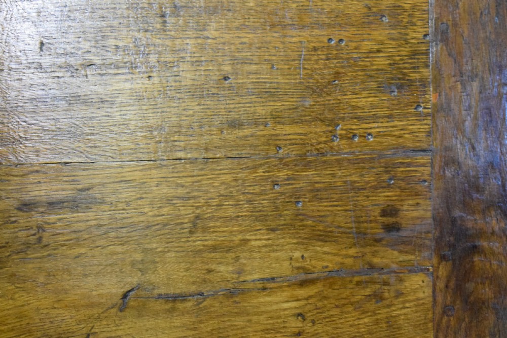 A dark oak seventeenth-century coffer featuring two plain rectangular front panels and a flat hinged top. View XXV