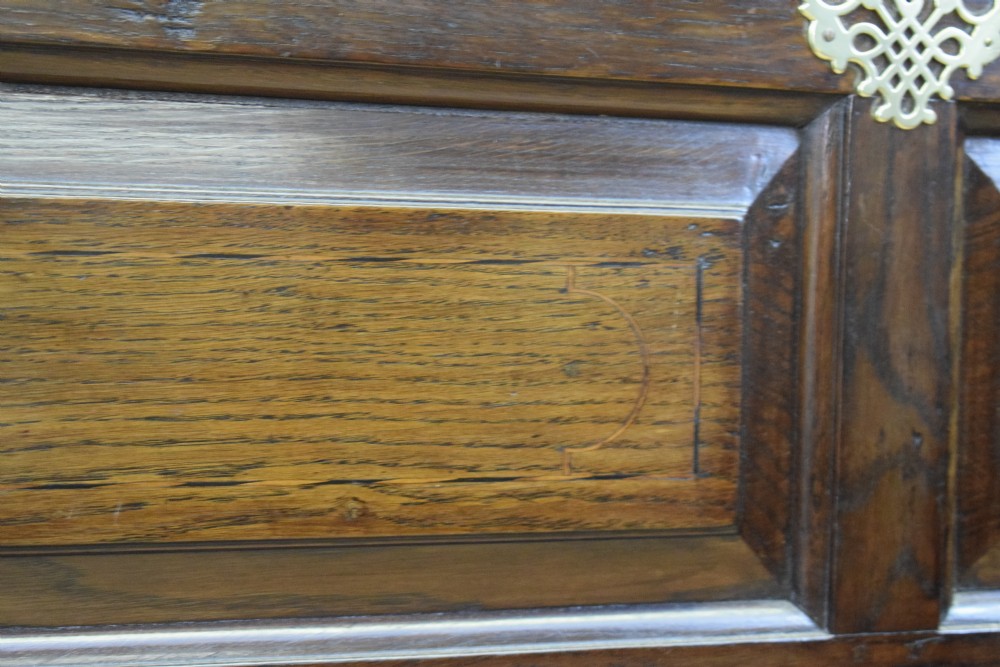 A Georgian dark oak Lancashire mule chest featuring a hinged top lid, panelled front sections with inlays, brass swan-neck handles, and bracket feet. View XX