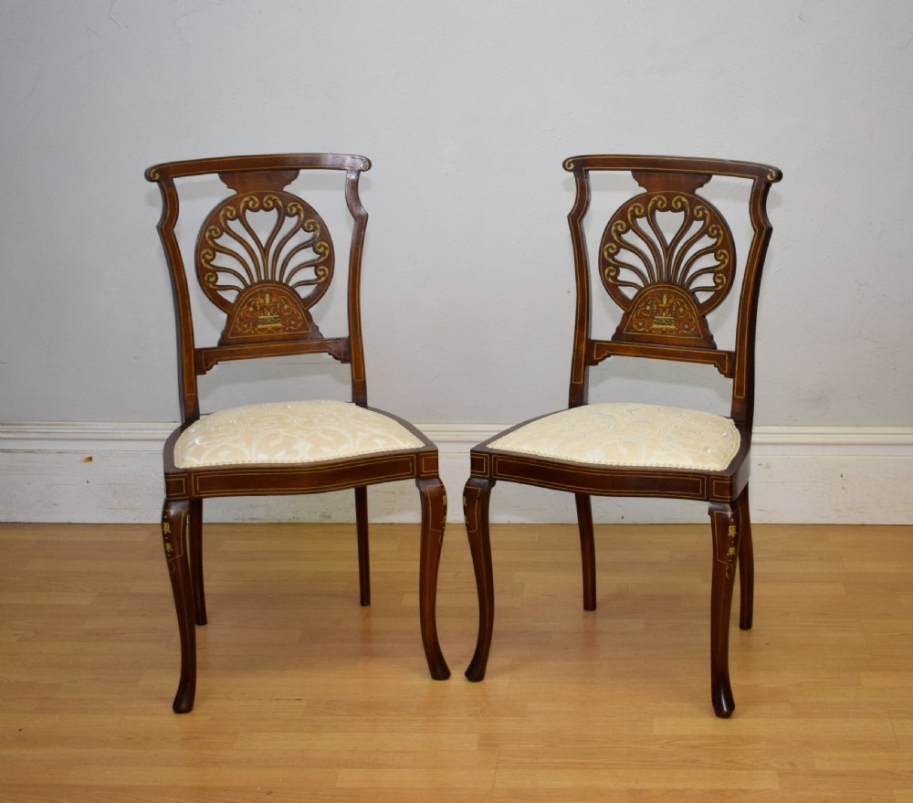 A pair of Victorian side chairs featuring dark mahogany frames with detailed marquetry inlays, fan-shaped pierced backrests, and cream upholstered seats. View II