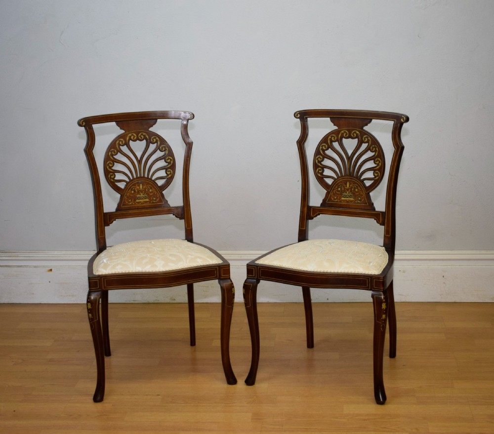 A pair of Victorian side chairs featuring dark mahogany frames with detailed marquetry inlays, fan-shaped pierced backrests, and cream upholstered seats. View VIII