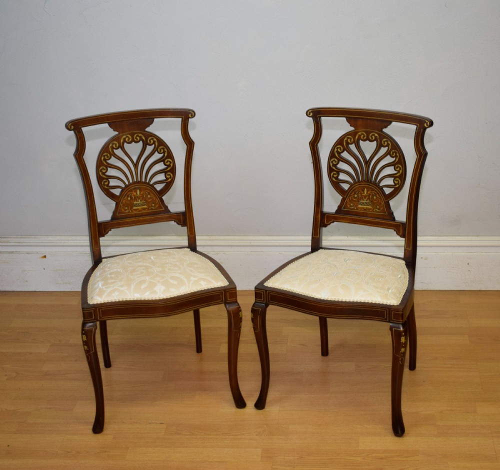 A pair of Victorian side chairs featuring dark mahogany frames with detailed marquetry inlays, fan-shaped pierced backrests, and cream upholstered seats. View IX