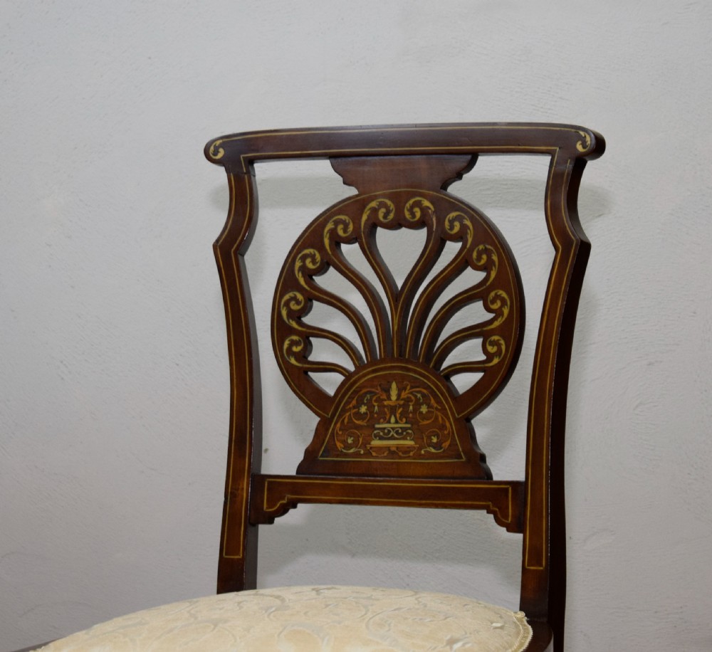 A pair of Victorian side chairs featuring dark mahogany frames with detailed marquetry inlays, fan-shaped pierced backrests, and cream upholstered seats. View XII