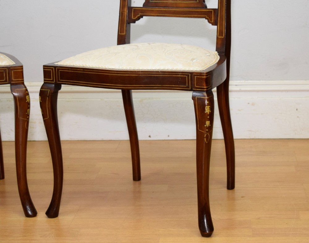 A pair of Victorian side chairs featuring dark mahogany frames with detailed marquetry inlays, fan-shaped pierced backrests, and cream upholstered seats. View XIII