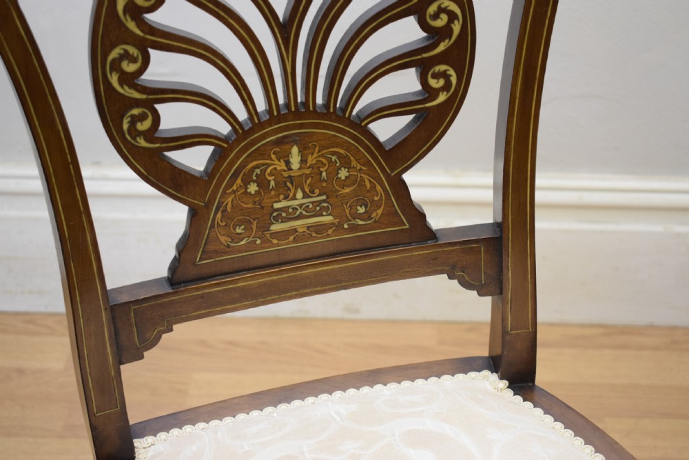 A pair of Victorian side chairs featuring dark mahogany frames with detailed marquetry inlays, fan-shaped pierced backrests, and cream upholstered seats. View XIV