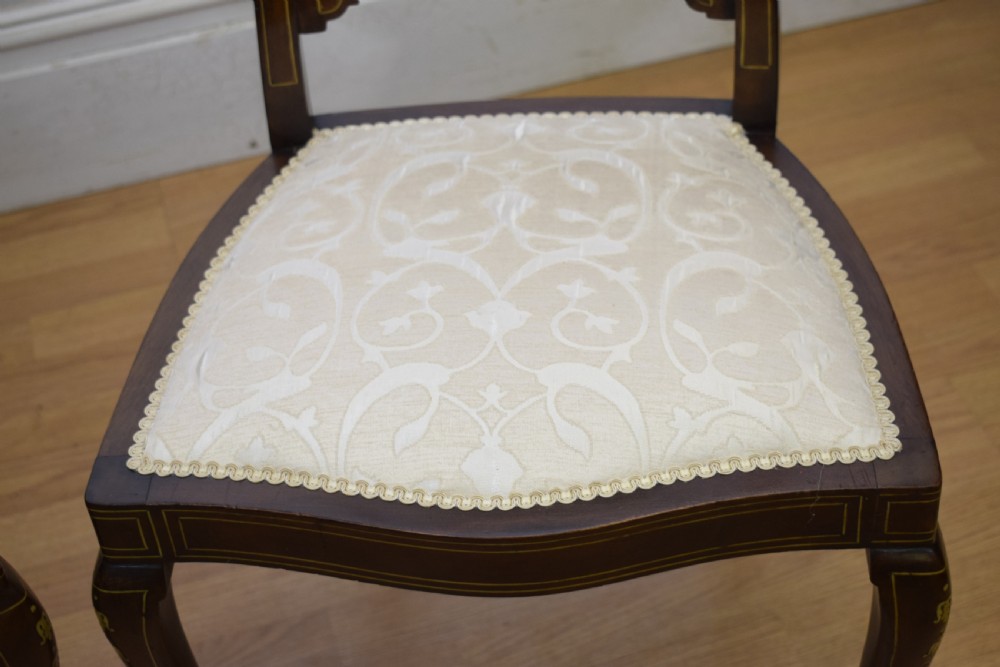 A pair of Victorian side chairs featuring dark mahogany frames with detailed marquetry inlays, fan-shaped pierced backrests, and cream upholstered seats. View XVI
