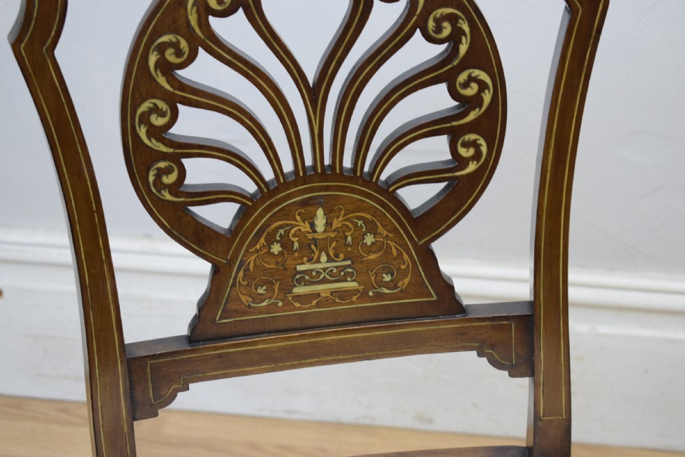 A pair of Victorian side chairs featuring dark mahogany frames with detailed marquetry inlays, fan-shaped pierced backrests, and cream upholstered seats. View XVIII