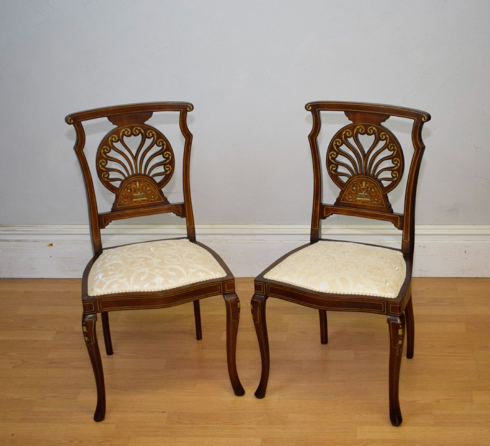 A pair of Victorian side chairs featuring dark mahogany frames with detailed marquetry inlays, fan-shaped pierced backrests, and cream upholstered seats. View XXII