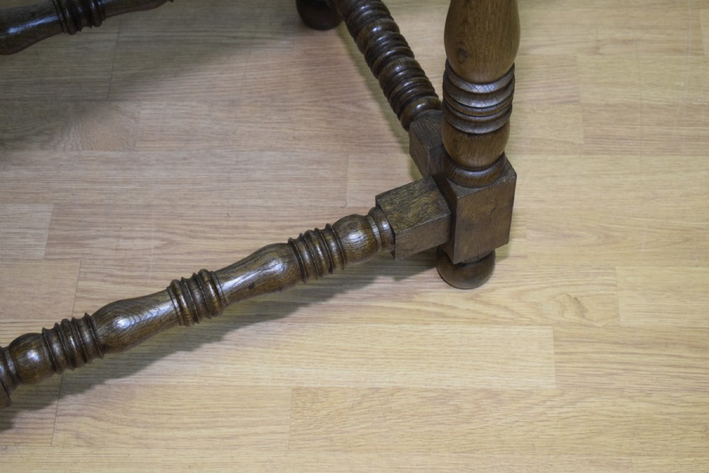 An early 20th-century oak console table featuring turned legs, a shaped apron, carved top edge, and low stretcher supports. View IX