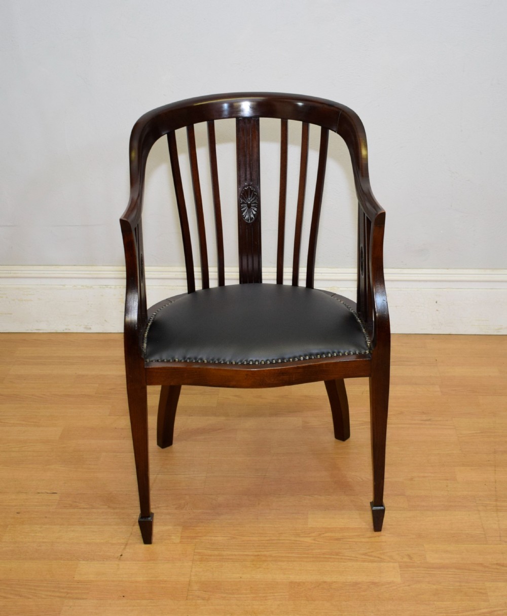 A Victorian dark mahogany tub chair featuring a curved backrest with vertical splats, a central carved oval patera, and a black leather studded seat. View II