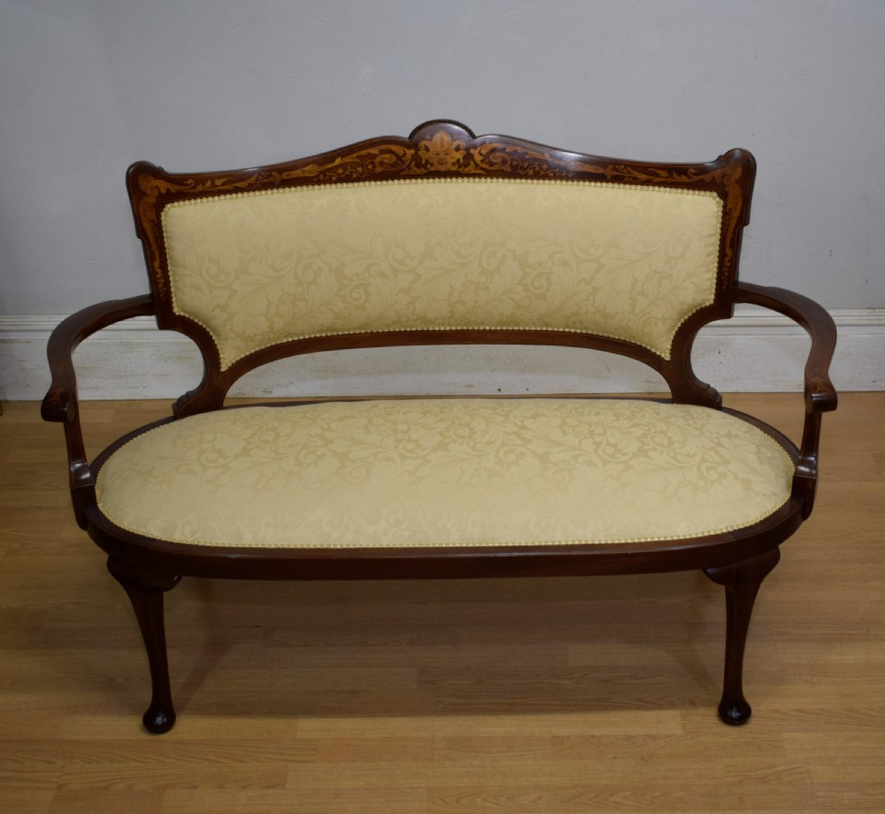 A Victorian dark mahogany settee with floral marquetry inlay along the crest rail and cream damask upholstered seat and backrest. View XI