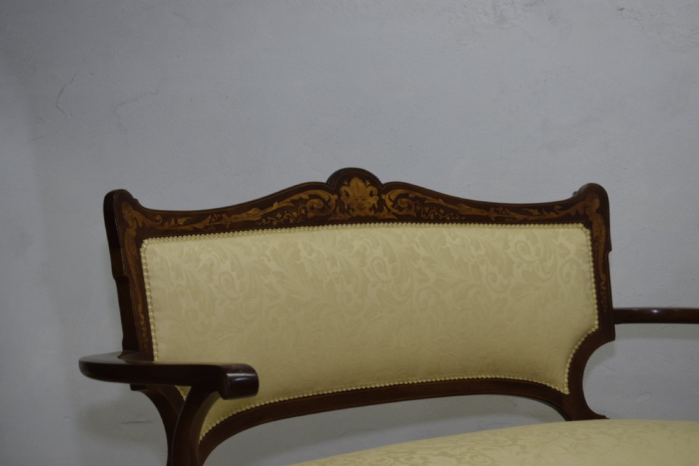 A Victorian dark mahogany settee with floral marquetry inlay along the crest rail and cream damask upholstered seat and backrest. View XIII