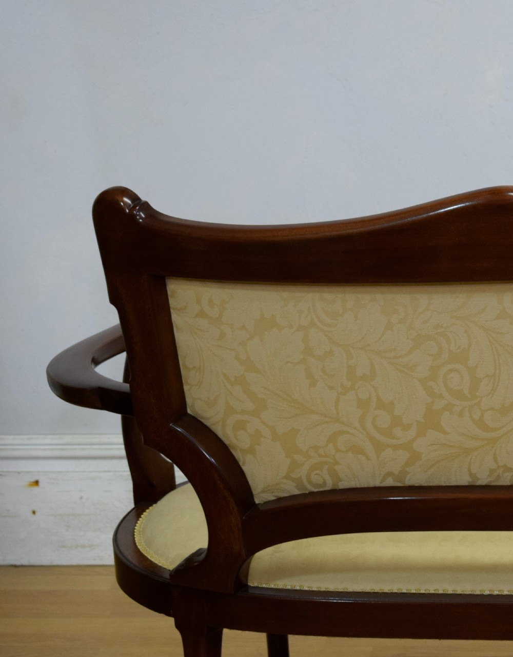 A Victorian dark mahogany settee with floral marquetry inlay along the crest rail and cream damask upholstered seat and backrest. View XXII