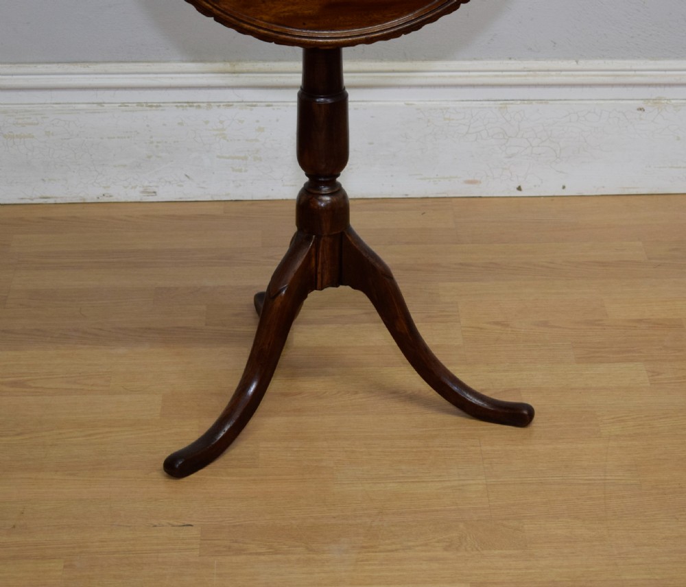 A dark mahogany Georgian tripod table featuring a circular top with a moulded rim, a turned central stem, and three splayed cabriole legs. View VIII