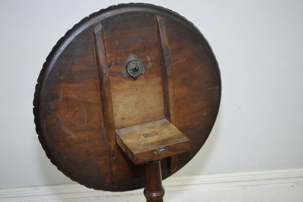 A dark mahogany Georgian tripod table featuring a circular top with a moulded rim, a turned central stem, and three splayed cabriole legs. View XIII