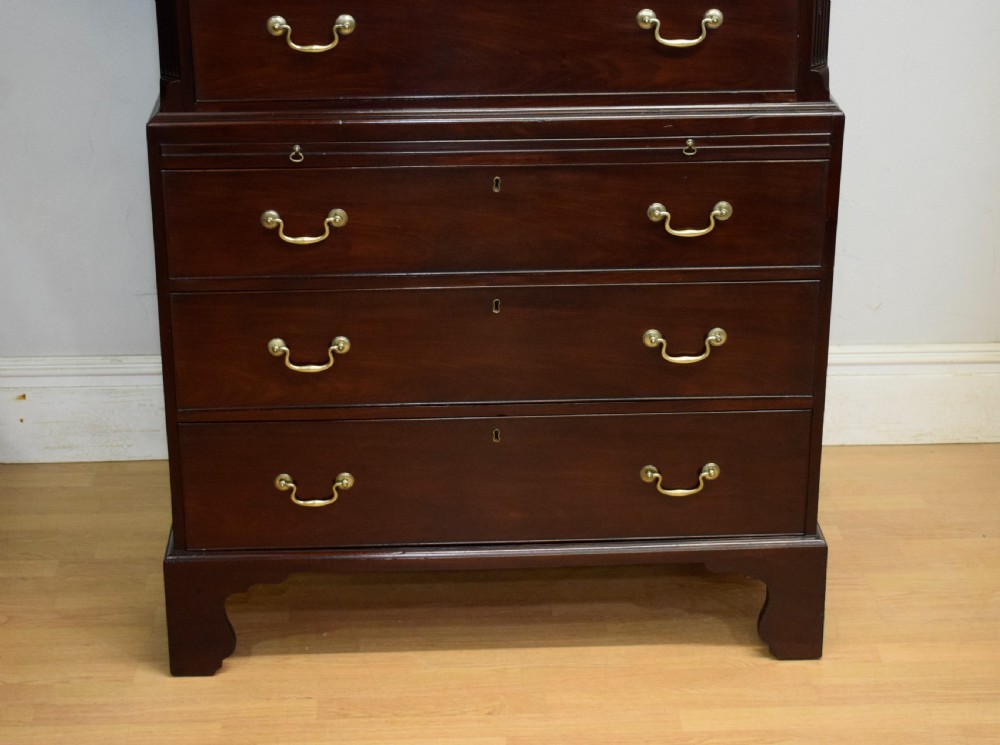 A Georgian mahogany chest on chest featuring two short over six long drawers with brass drop handles and fluted side columns on bracket feet. View VI