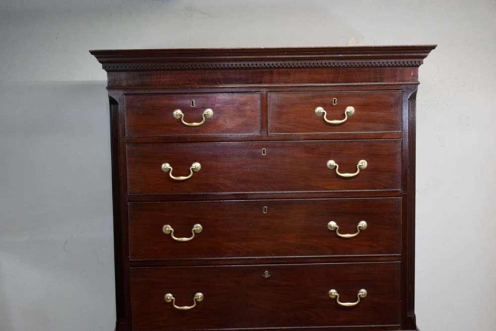 A Georgian mahogany chest on chest featuring two short over six long drawers with brass drop handles and fluted side columns on bracket feet. View VII