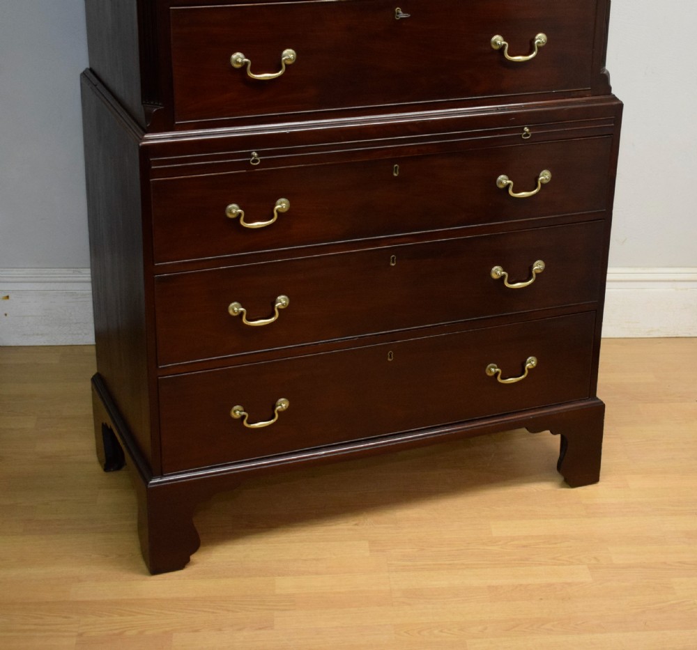A Georgian mahogany chest on chest featuring two short over six long drawers with brass drop handles and fluted side columns on bracket feet. View XI