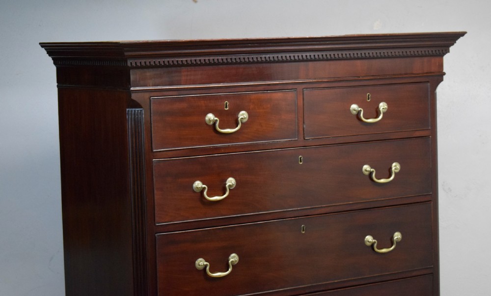 A Georgian mahogany chest on chest featuring two short over six long drawers with brass drop handles and fluted side columns on bracket feet. View XVII