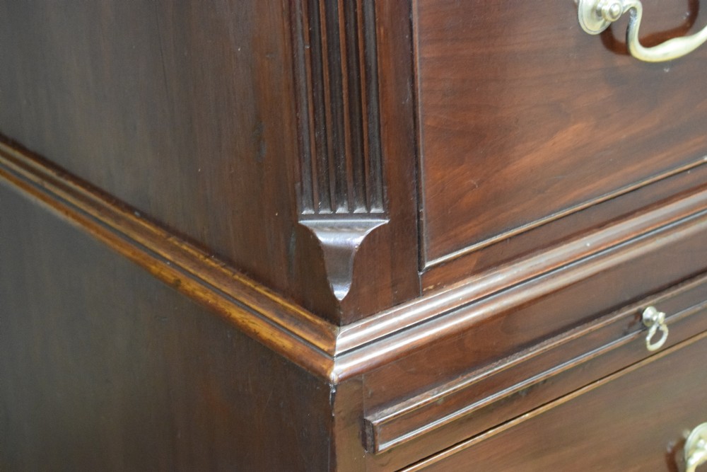 A Georgian mahogany chest on chest featuring two short over six long drawers with brass drop handles and fluted side columns on bracket feet. View XXII