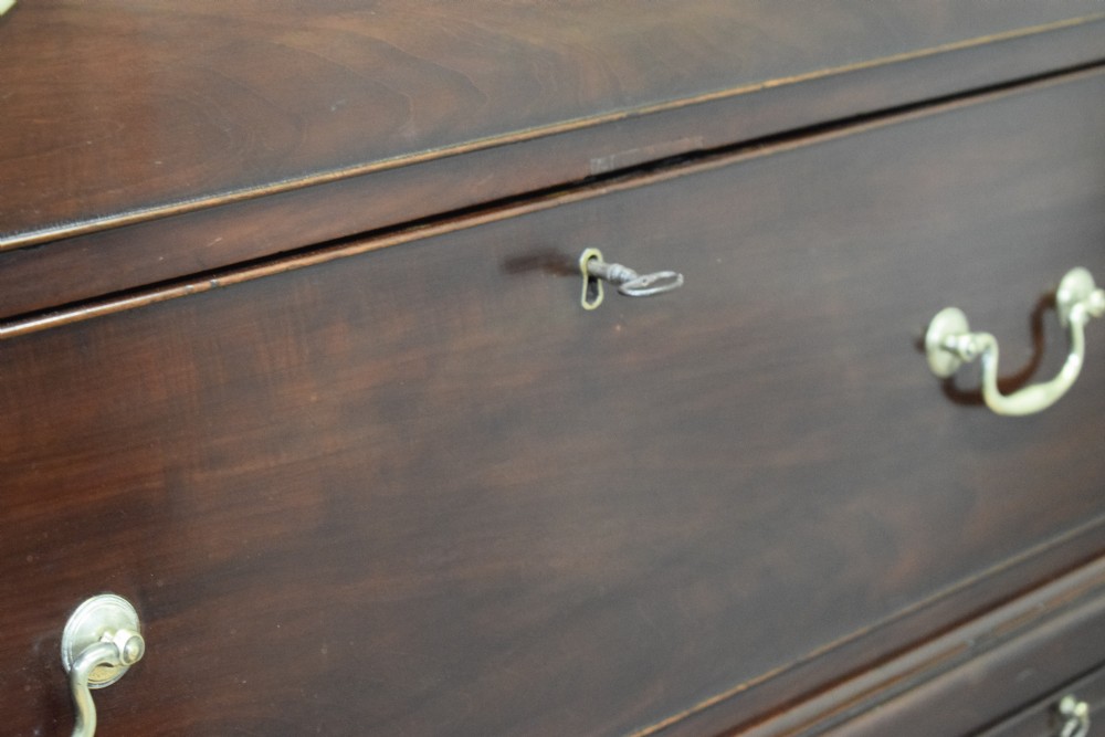 A Georgian mahogany chest on chest featuring two short over six long drawers with brass drop handles and fluted side columns on bracket feet. View XXIII
