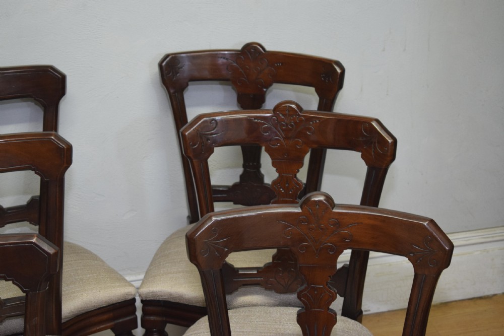 A set of six Victorian mahogany dining chairs featuring carved open backs, turned front legs, and neutral upholstered seats. View XI