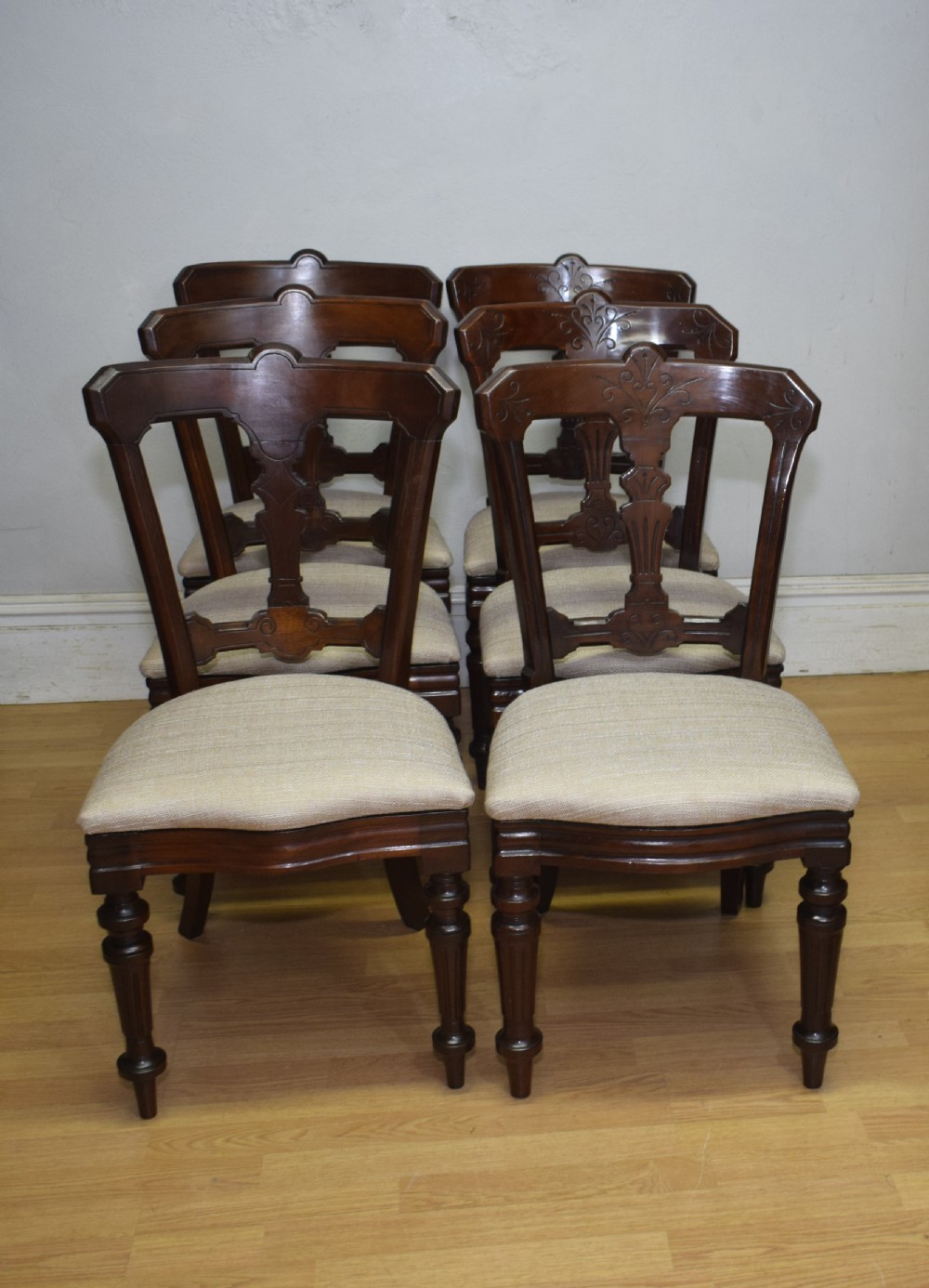 A set of six Victorian mahogany dining chairs featuring carved open backs, turned front legs, and neutral upholstered seats. View XII