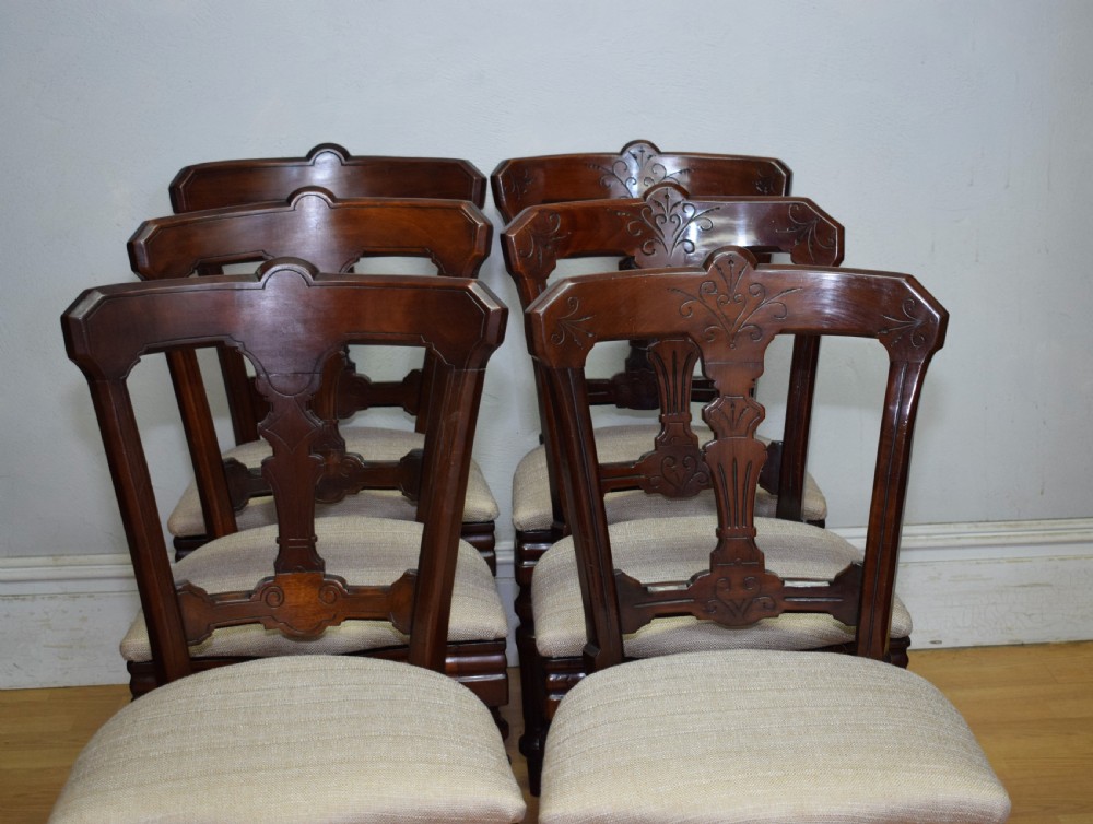 A set of six Victorian mahogany dining chairs featuring carved open backs, turned front legs, and neutral upholstered seats. View XIII