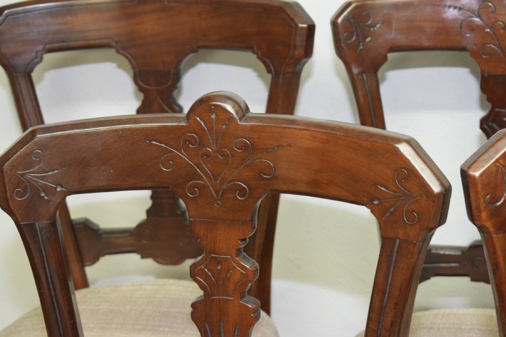 A set of six Victorian mahogany dining chairs featuring carved open backs, turned front legs, and neutral upholstered seats. View XVIII