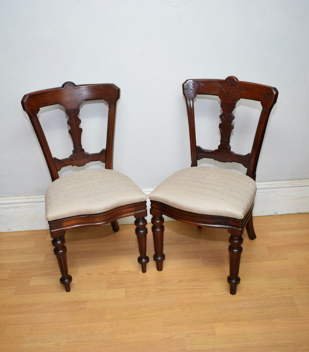 A set of six Victorian mahogany dining chairs featuring carved open backs, turned front legs, and neutral upholstered seats. View XXI
